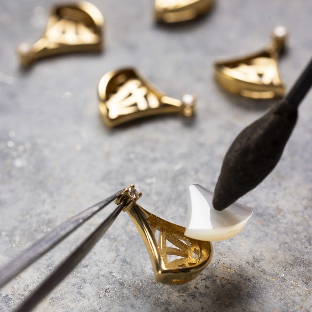 Hand working on Divas' Dream pendant.