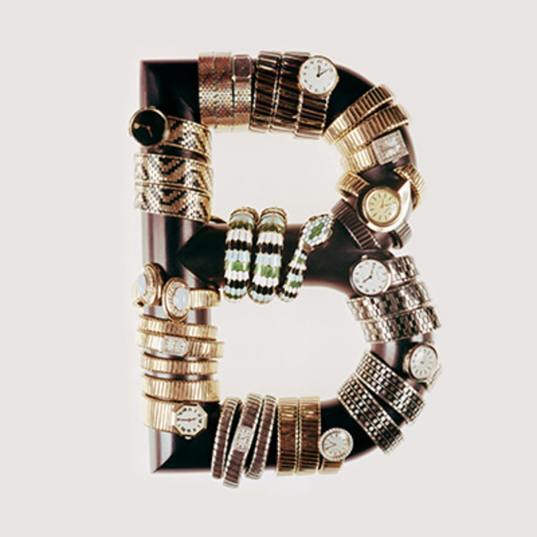 Multiple Serpenti and Tubogas heritage watches wrapping around the Bulgari B, vintage advertising campaign.