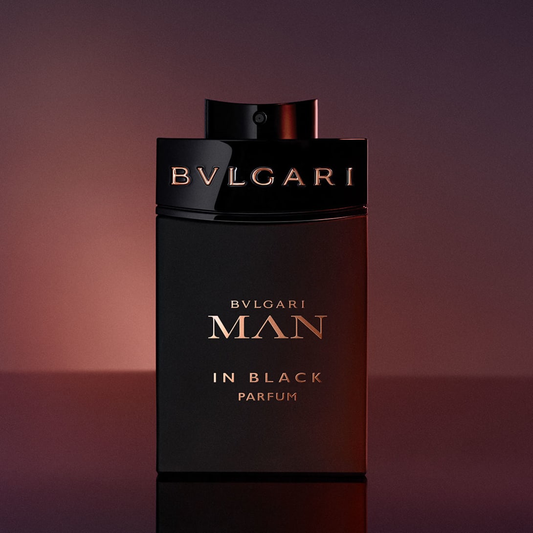 Bvlgari Man in Black Eau de Toilette and Eau de Parfum bottles, purple sky.