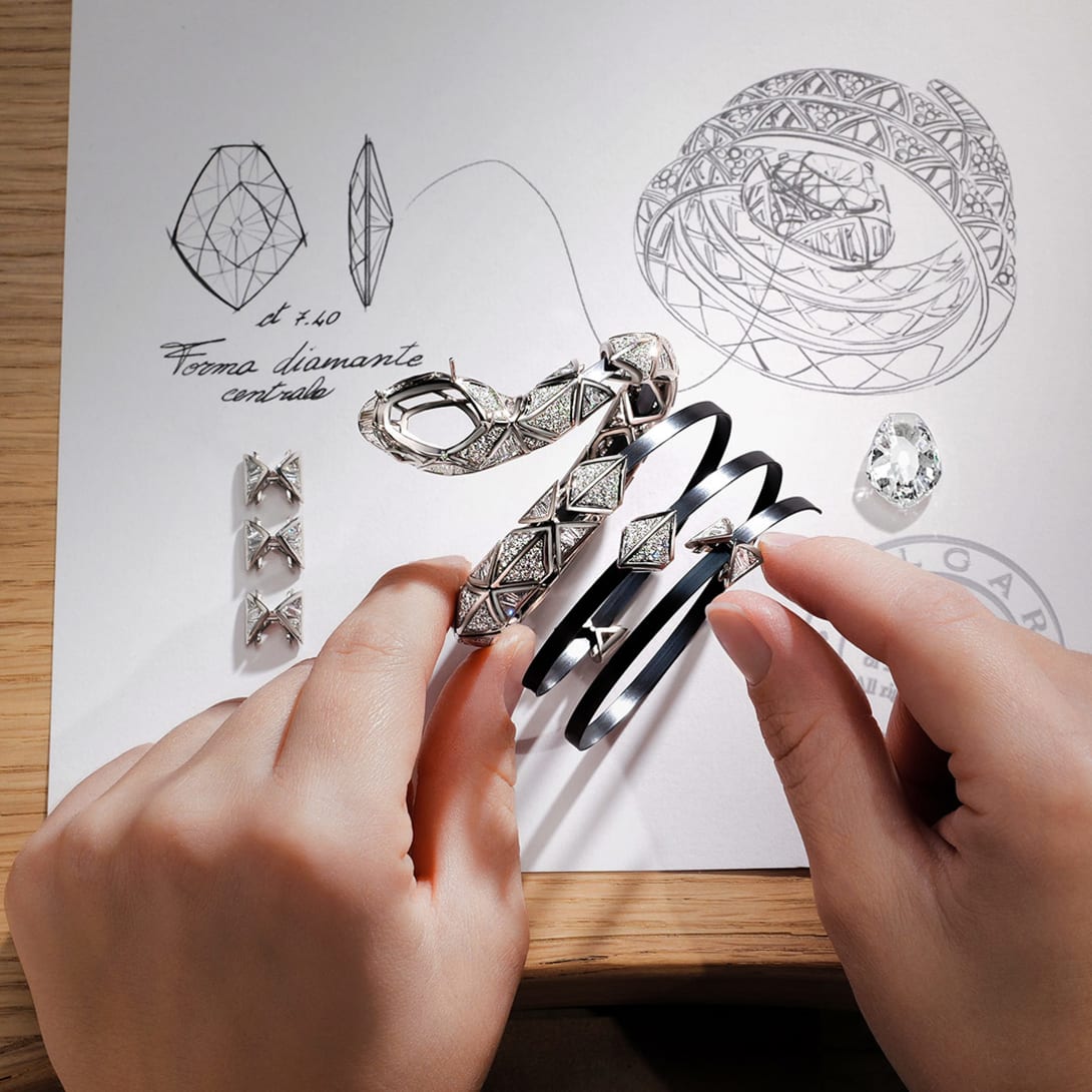 Making of Serpenti Infinia High Jewellery double-spiral bracelet with diamonds, sketch behind.