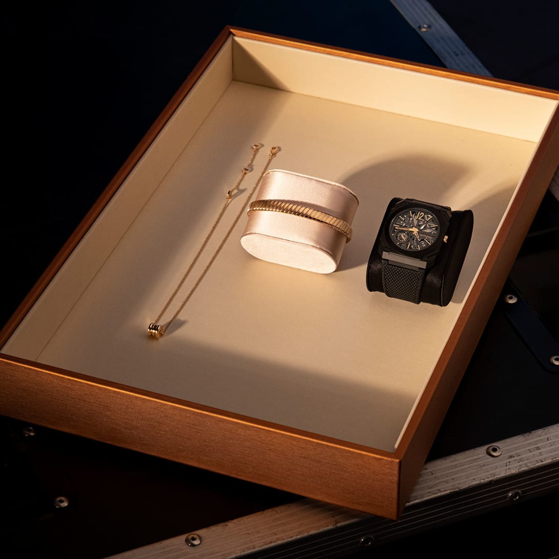 Tray displaying Bvlgari watches and jewelry