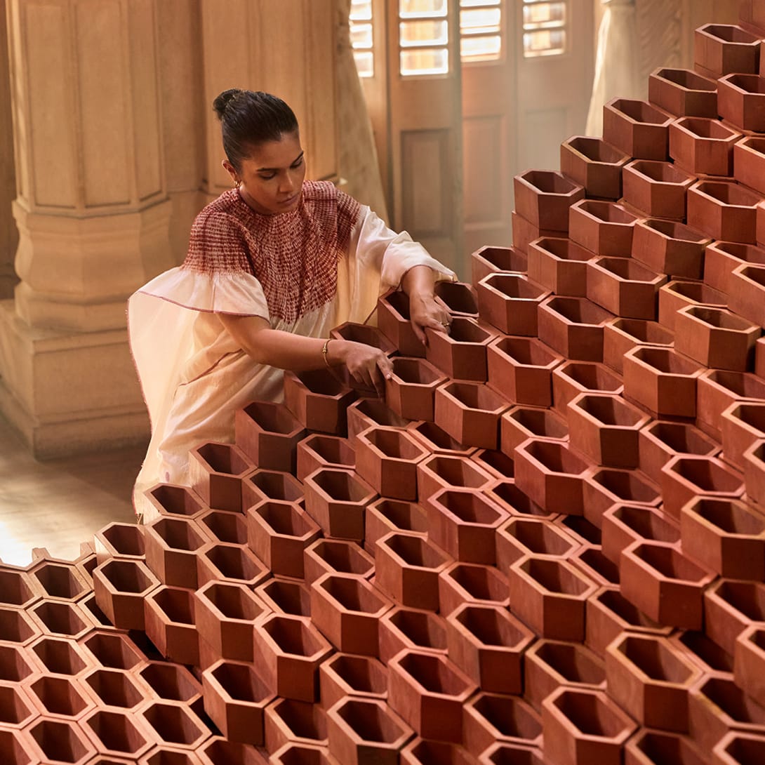 Indian artist Doyel Joshi assembling her terracotta Passing The Light installation.