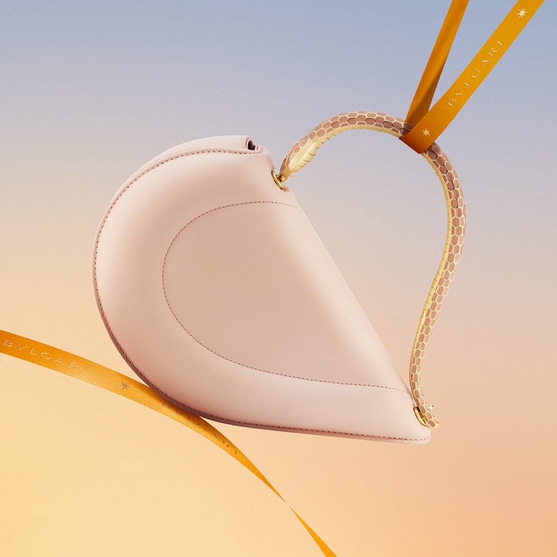 Bvlgari Cuore heart-shaped bag with metallic snake handle.