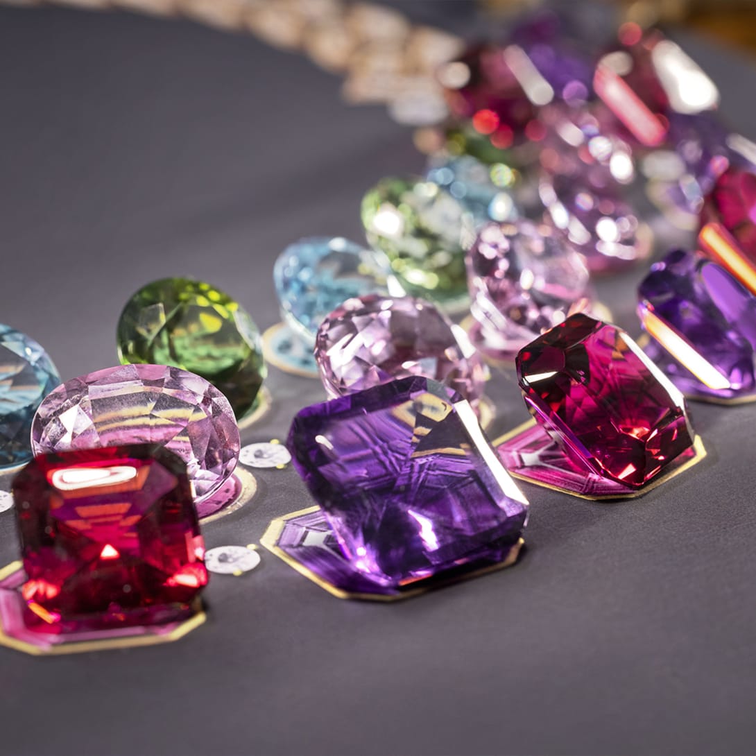 Model wearing The Earth Song High Jewellery necklace with pink tourmaline, amethyst, kunzite and round-cut diamonds, close-up.