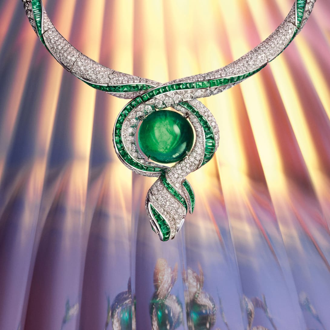 Model wearing The Terra Mater Serpenti High Jewellery necklace with emeralds and diamonds, close-up.