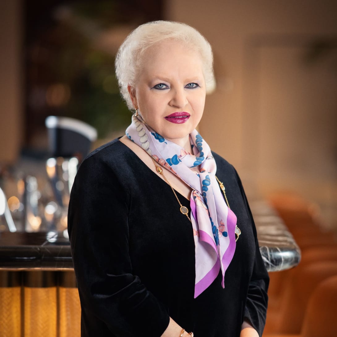 Isabelle Catellini, Human Resources Vice President, standing inside the Bulgari Hotel