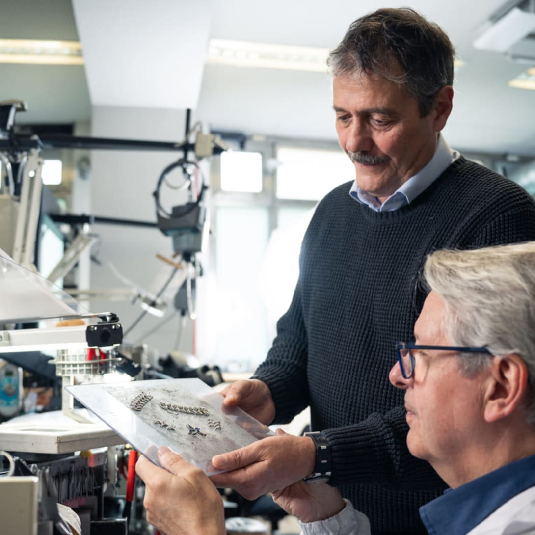 Massimo, High Jewelry Production Senior Director, checks parts of jewelry with a senior goldsmith