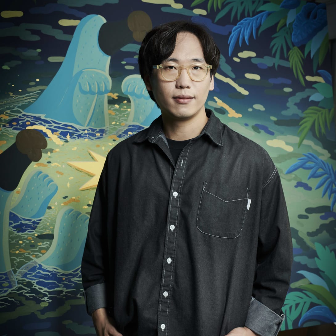 Contemporary artist Sunwoo Kim, who collaborated on the Serpenti in Art project, in front of his painting.