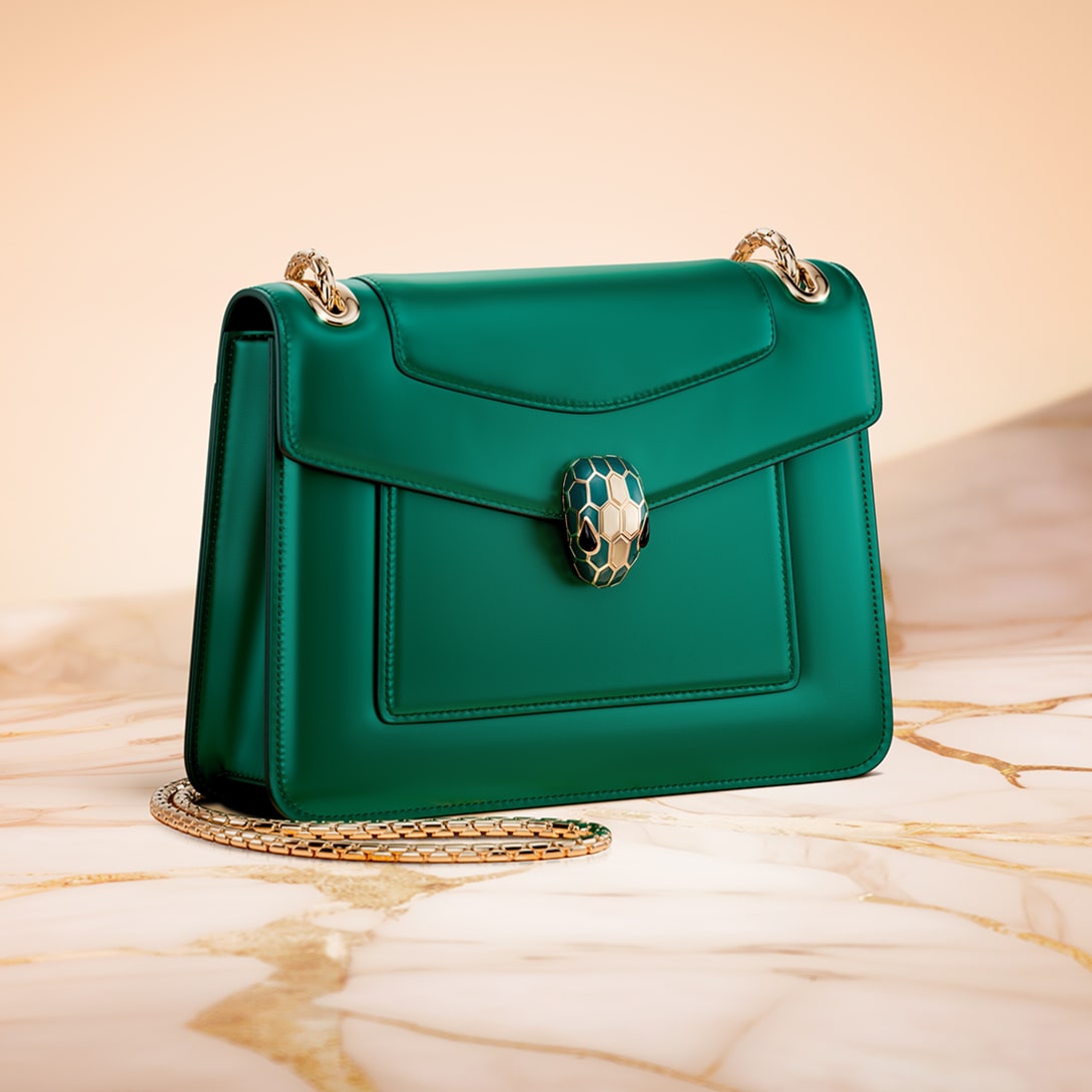 Serpenti Forever shoulder bag in emerald green calfskin with snakehead jewel-closure.