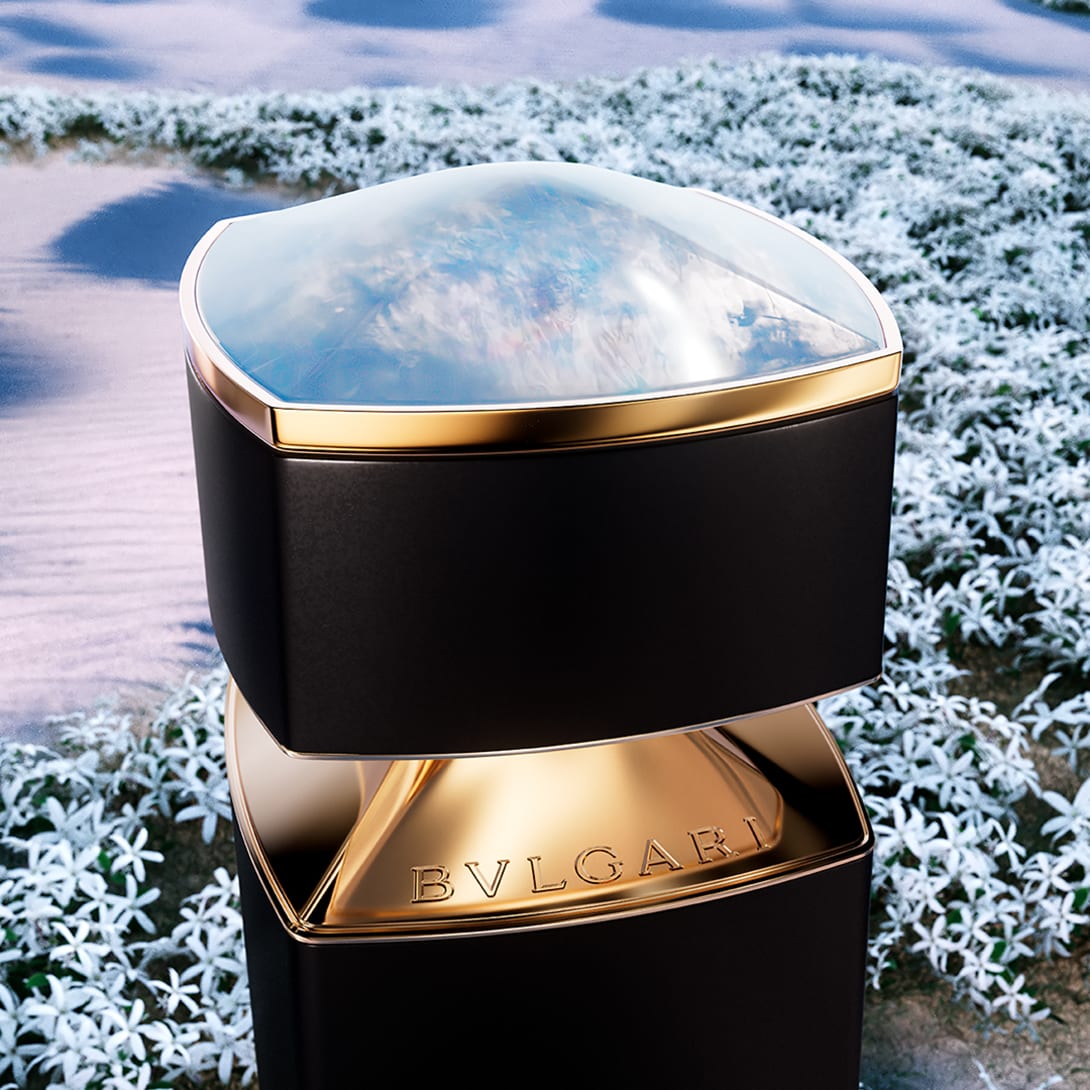 Bvlgari Le Gemme Amunae bottle with moonstone insert on the cap and jasmine flowers in the back.