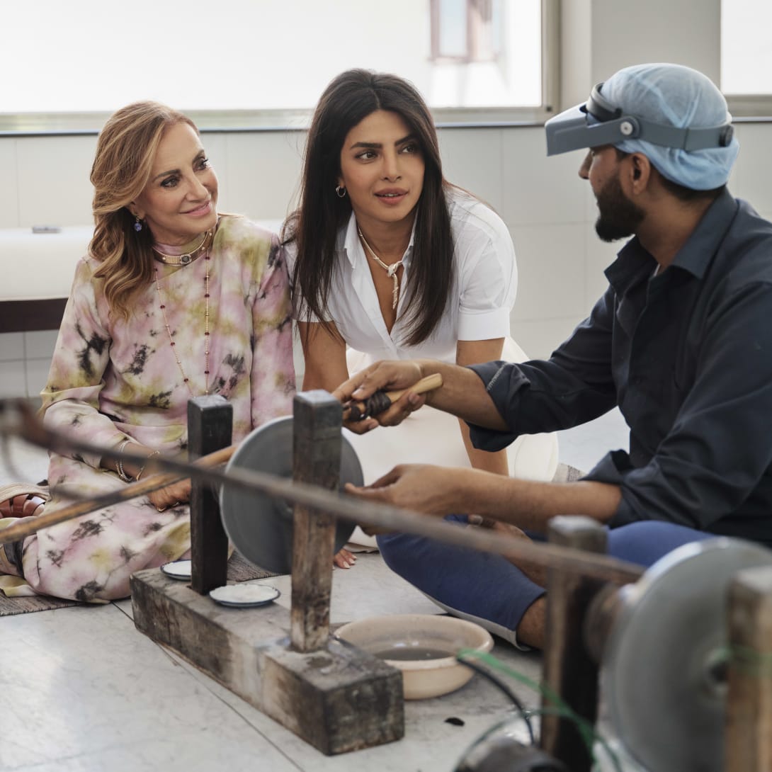 Priyanka Chopra Jonas and Lucia Silvestri observing a gemstone cutter at work in Jaipur.