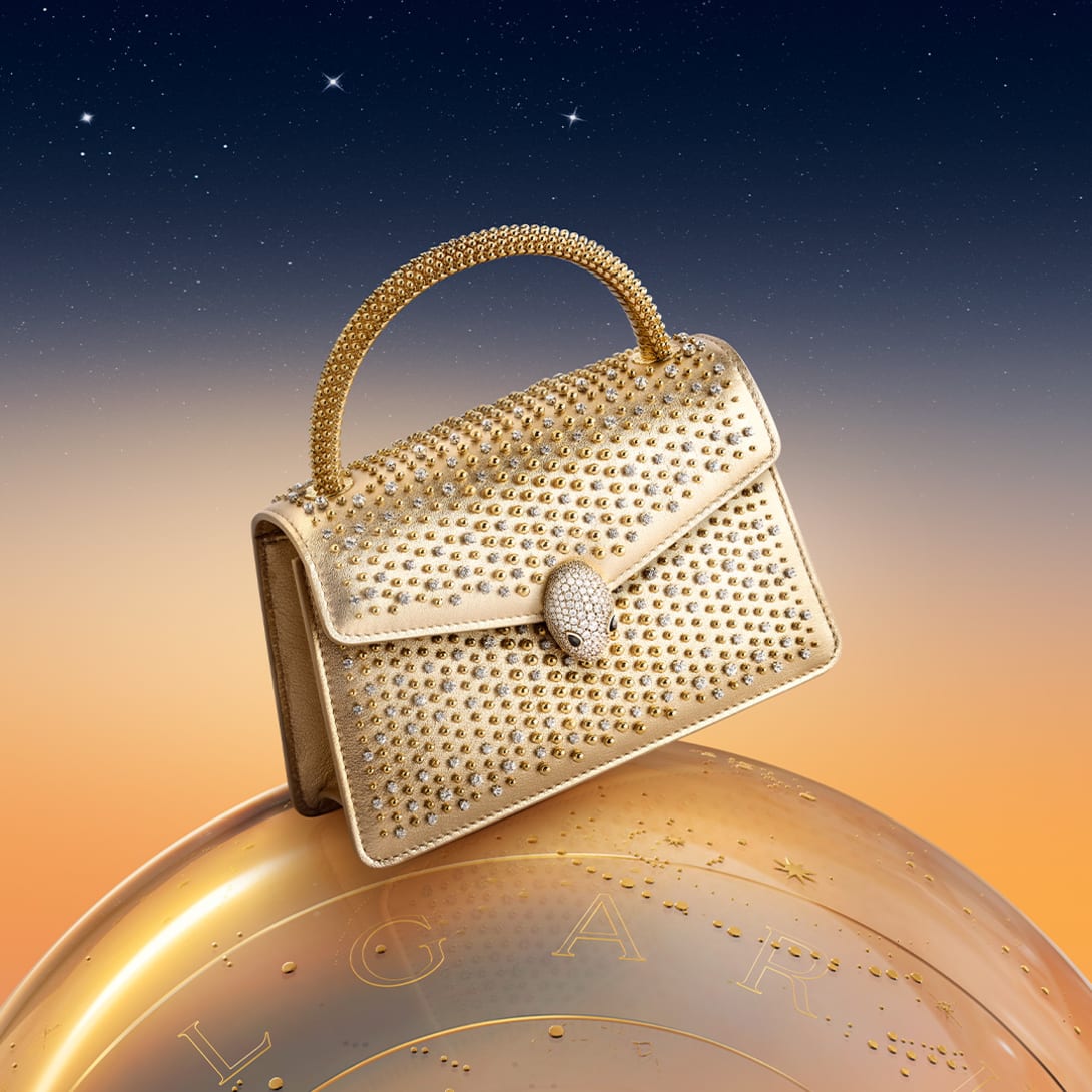 Serpenti Pallini bag with metallic top handle, studs and snakehead closure, starry night sky.
