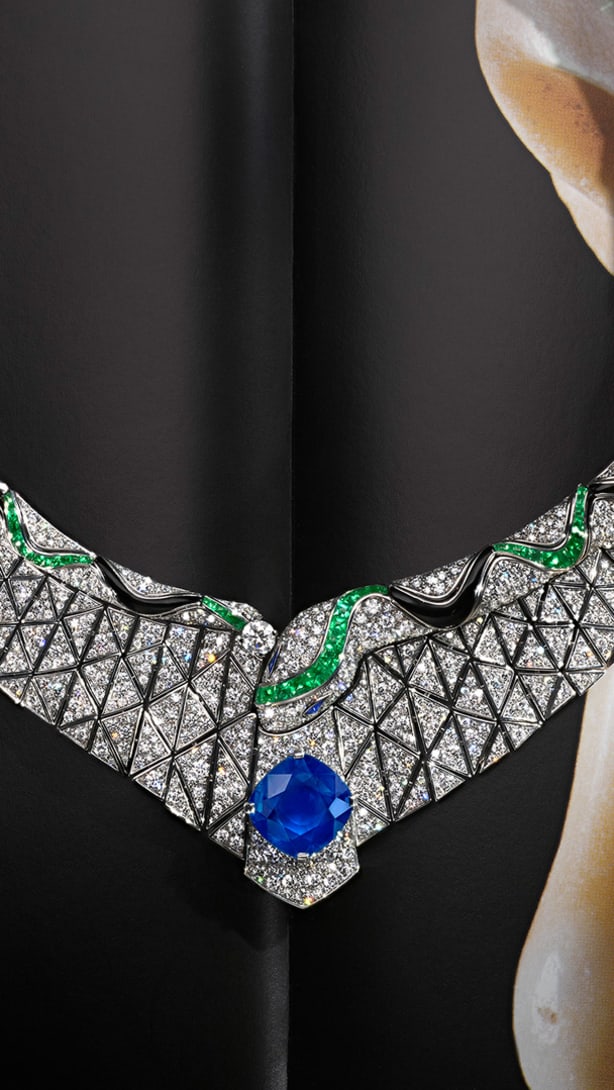 Serpenti Illusio High Jewellery white gold necklace set with a cushion sapphire, diamonds, onyx and emeralds.