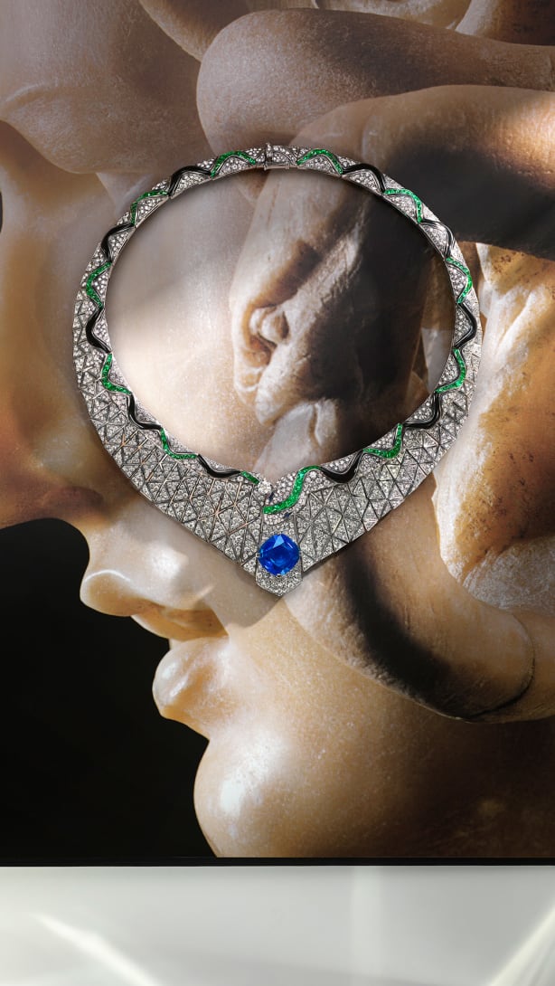 Serpenti Illusio High Jewellery white gold necklace set with a cushion sapphire, diamonds, onyx and emeralds.