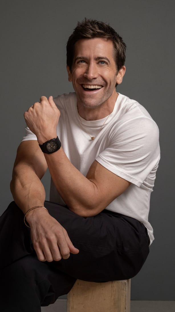 Jake Gyllenhaal wearing Octo Finissimo ultra-thin black titanium watch and B.zero1 necklace.
