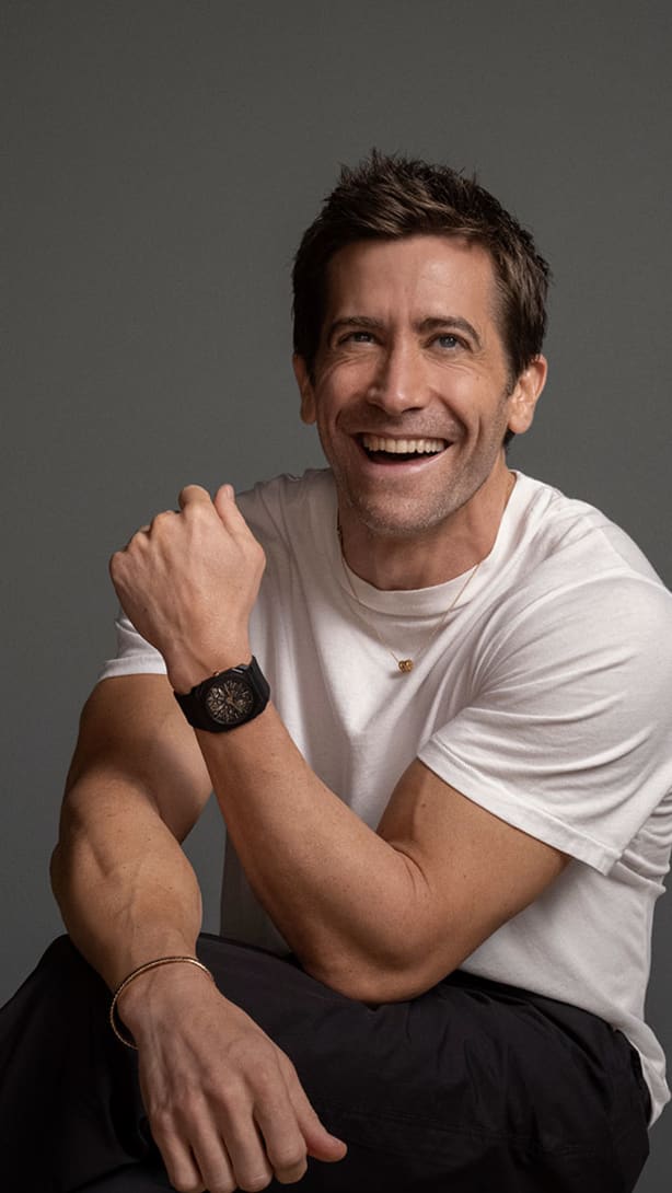 Jake Gyllenhaal wearing Octo Finissimo ultra-thin black titanium watch and B.zero1 necklace.
