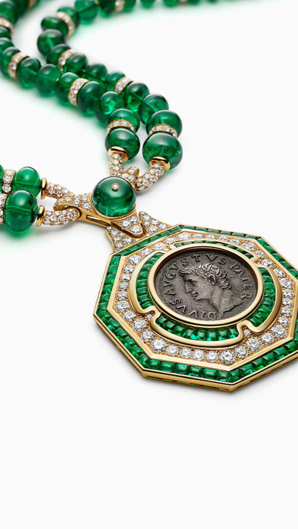 The Augustus Aeternus Emerald Monete High Jewellery sautoir with a rare bronze coin, emeralds and diamonds, full view.