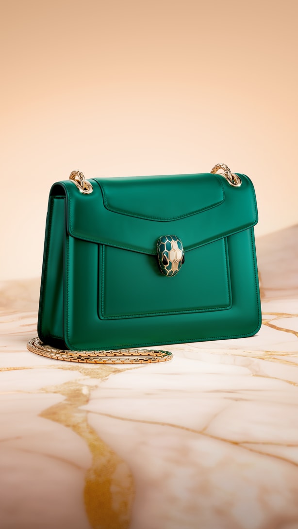 Serpenti Forever shoulder bag in emerald green calfskin with snakehead jewel-closure.