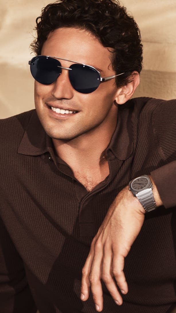 Model wearing Octo Finissimo pilot sunglasses in titanium and an Octo Finissimo watch.