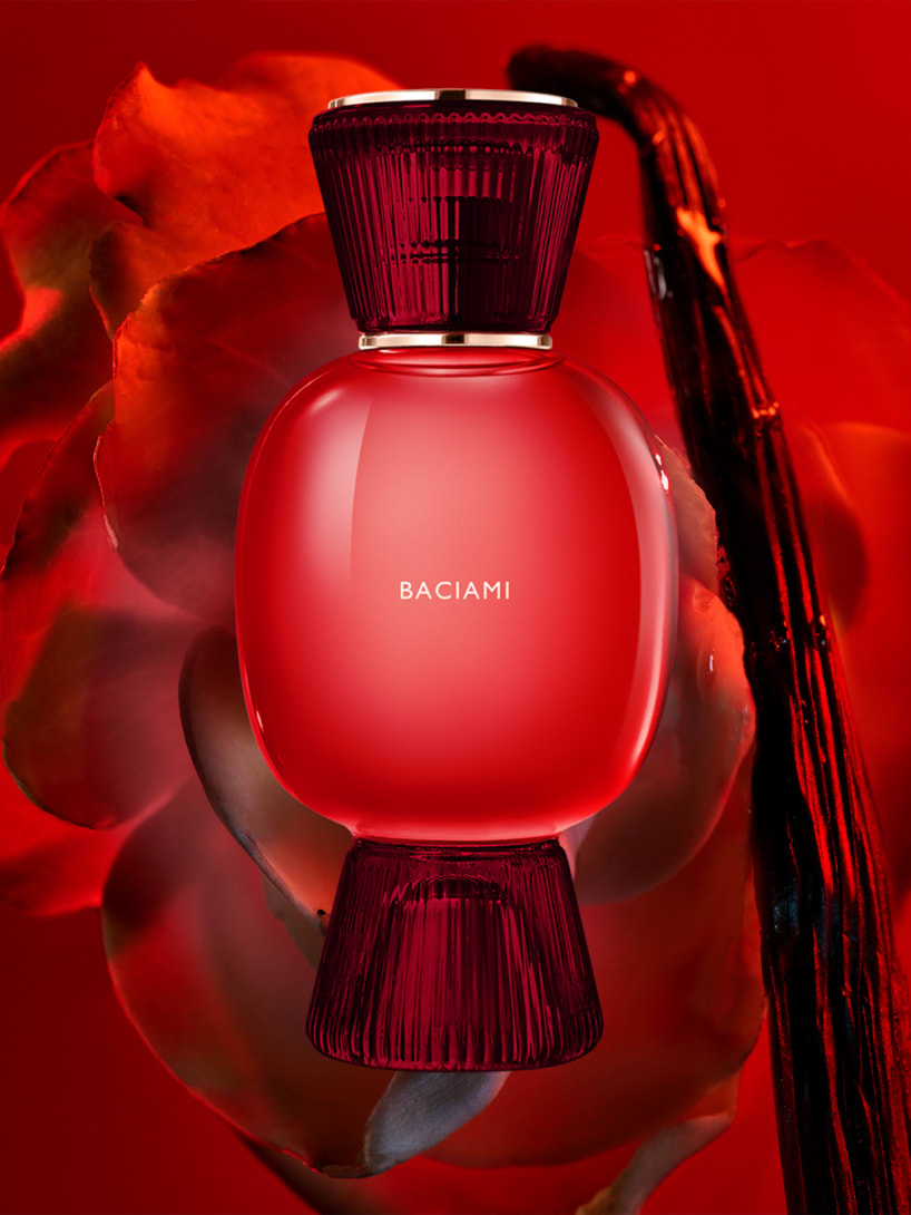 Bulgari Baciami Allegra fragrance flacon in red glass, Bulgari Allegra Magnifying Essence all-white flacon, creative shot.