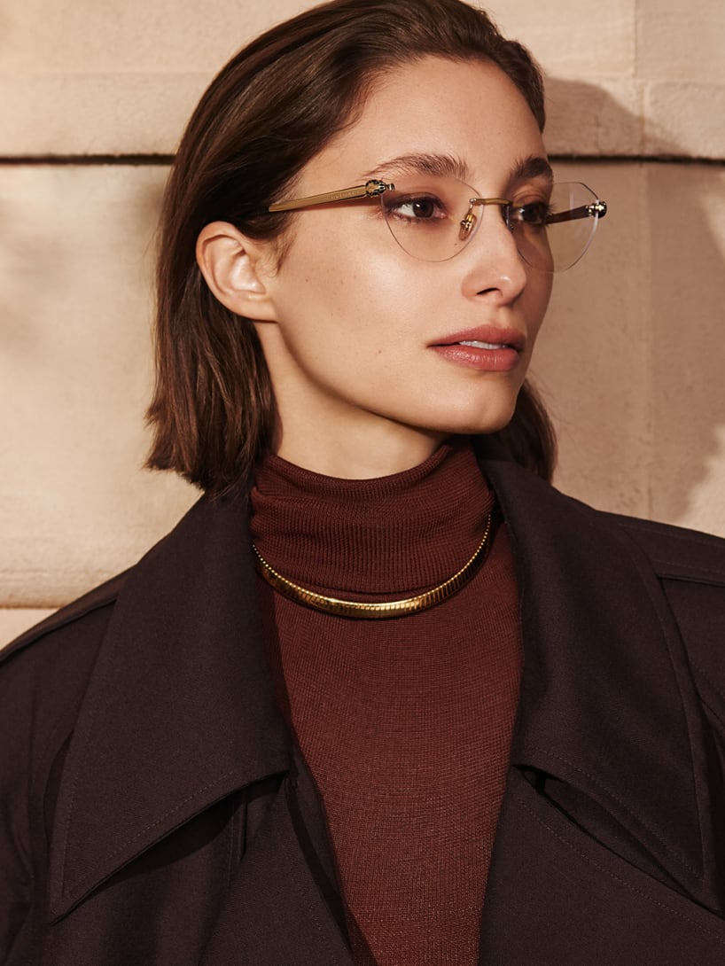 Model wearing Serpenti Forever rimless cat eye frames and a Bvlgari Tubogas gold necklace.