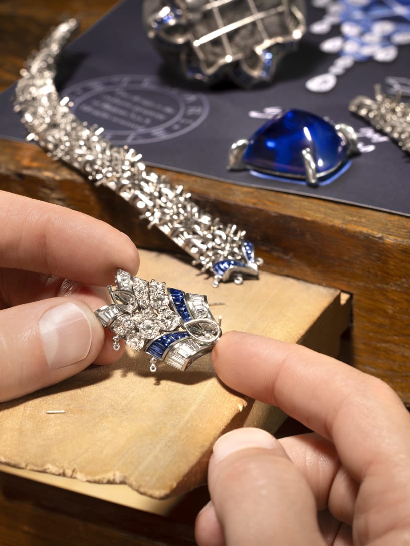 Hand holding Cosmic Vault Necklace, Polychroma High Jewellery collection.