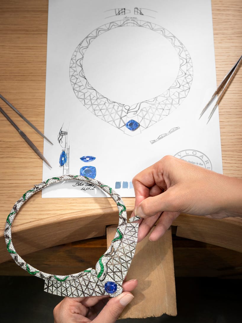Making of Serpenti Illusio High Jewellery necklace with a sapphire, diamonds, emeralds, sketch behind.