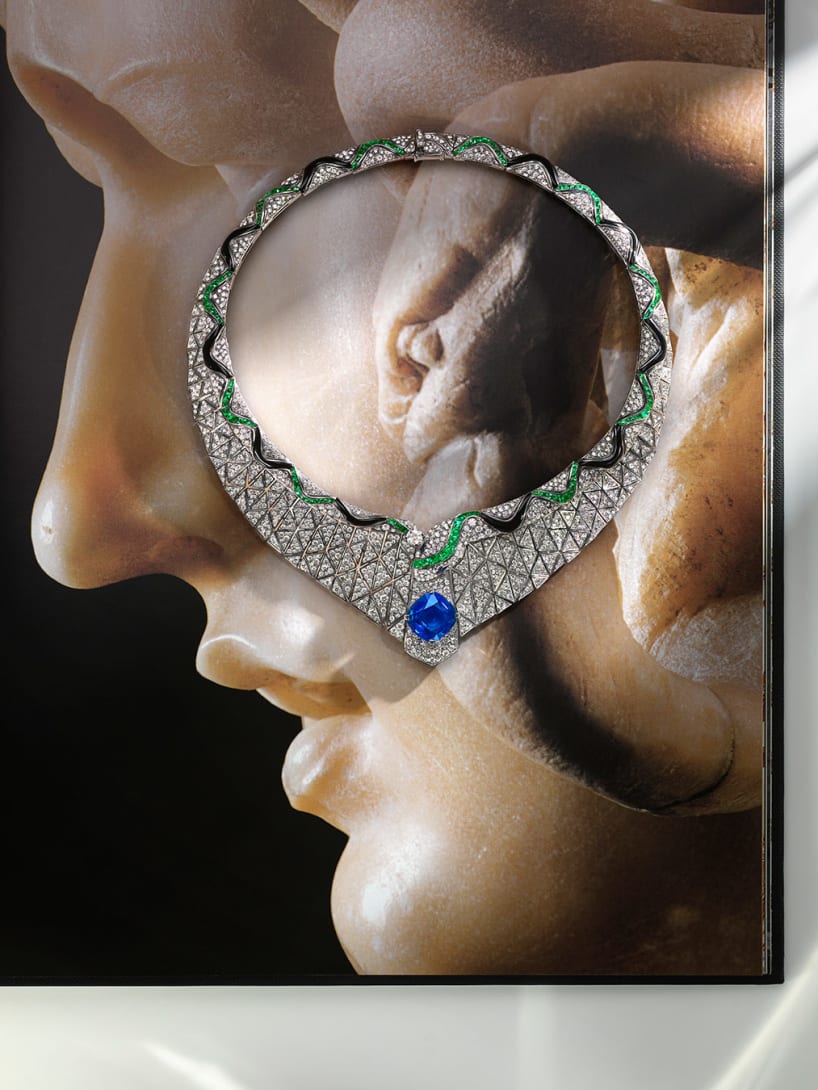 Serpenti Illusio High Jewellery white gold necklace set with a cushion sapphire, diamonds, onyx and emeralds.