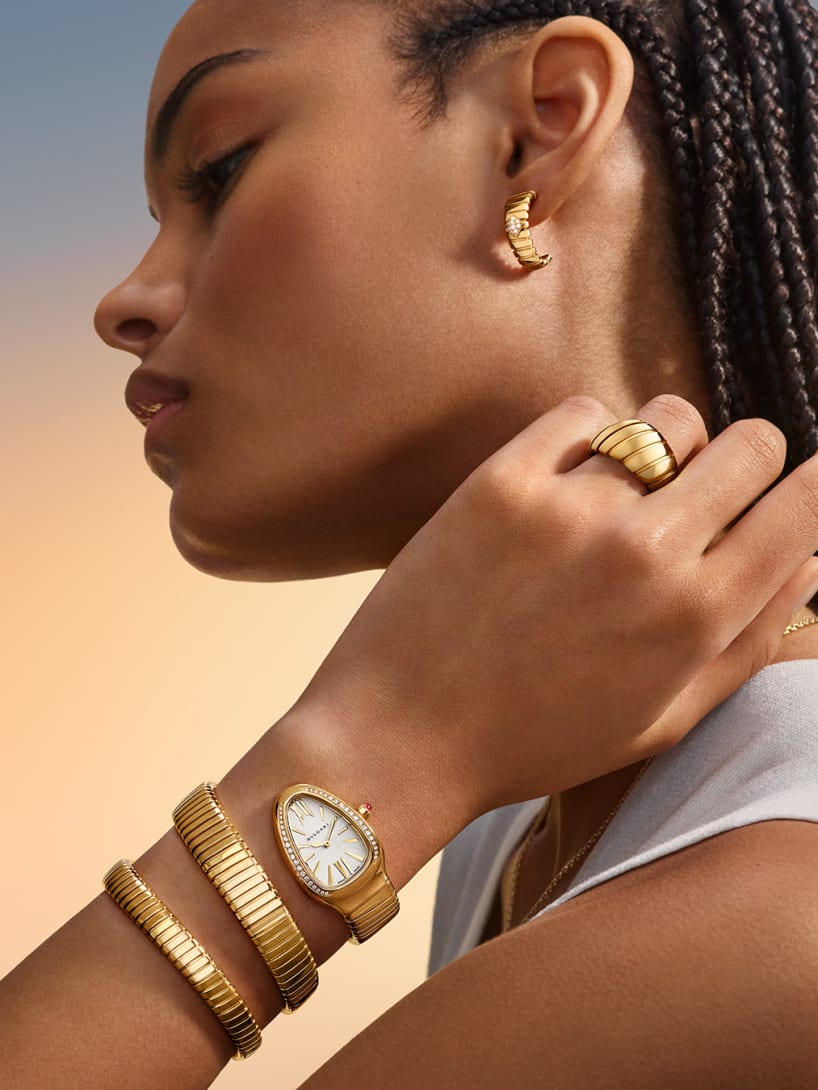 Model wearing Serpenti Tubogas watch, and Bvlgari Tubogas ring and earring.