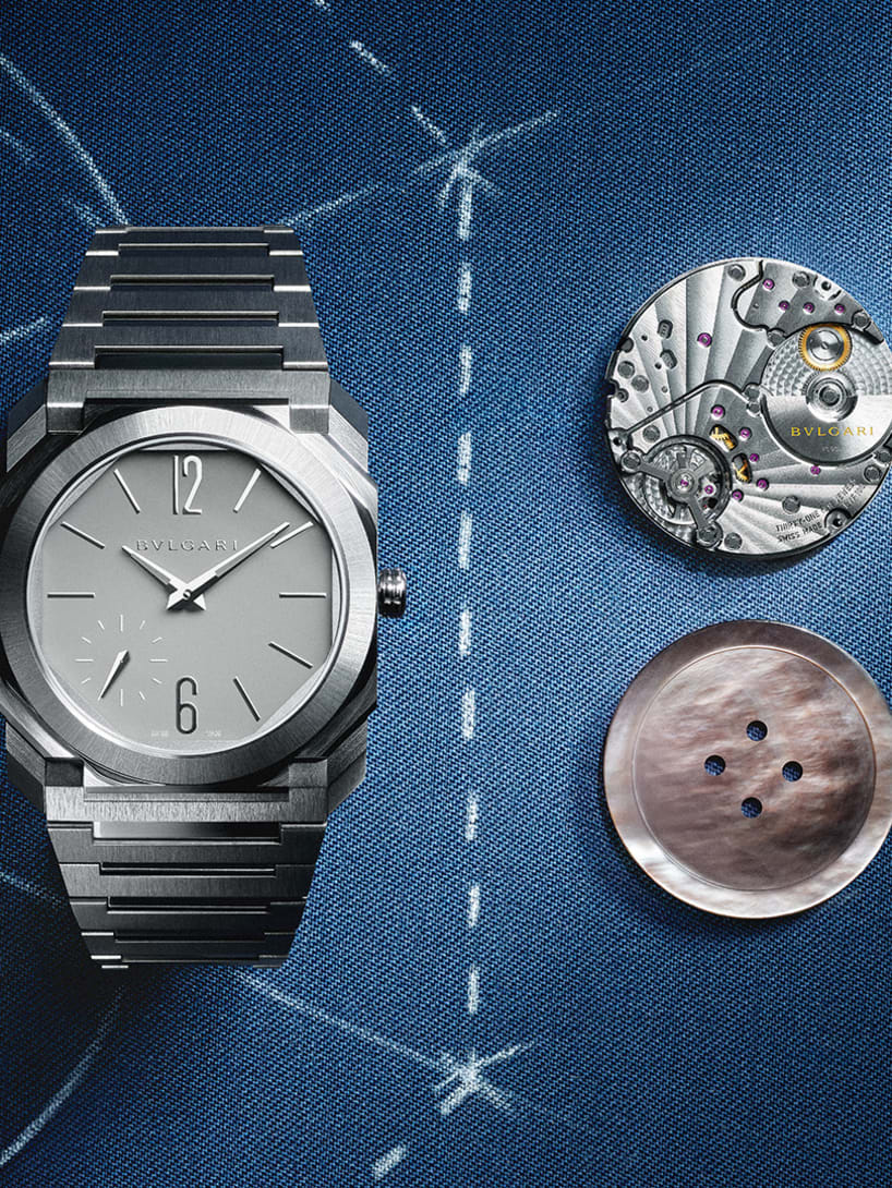 Octo Finissimo Automatic 37 mm watch with movement and button in the same size on blue background.