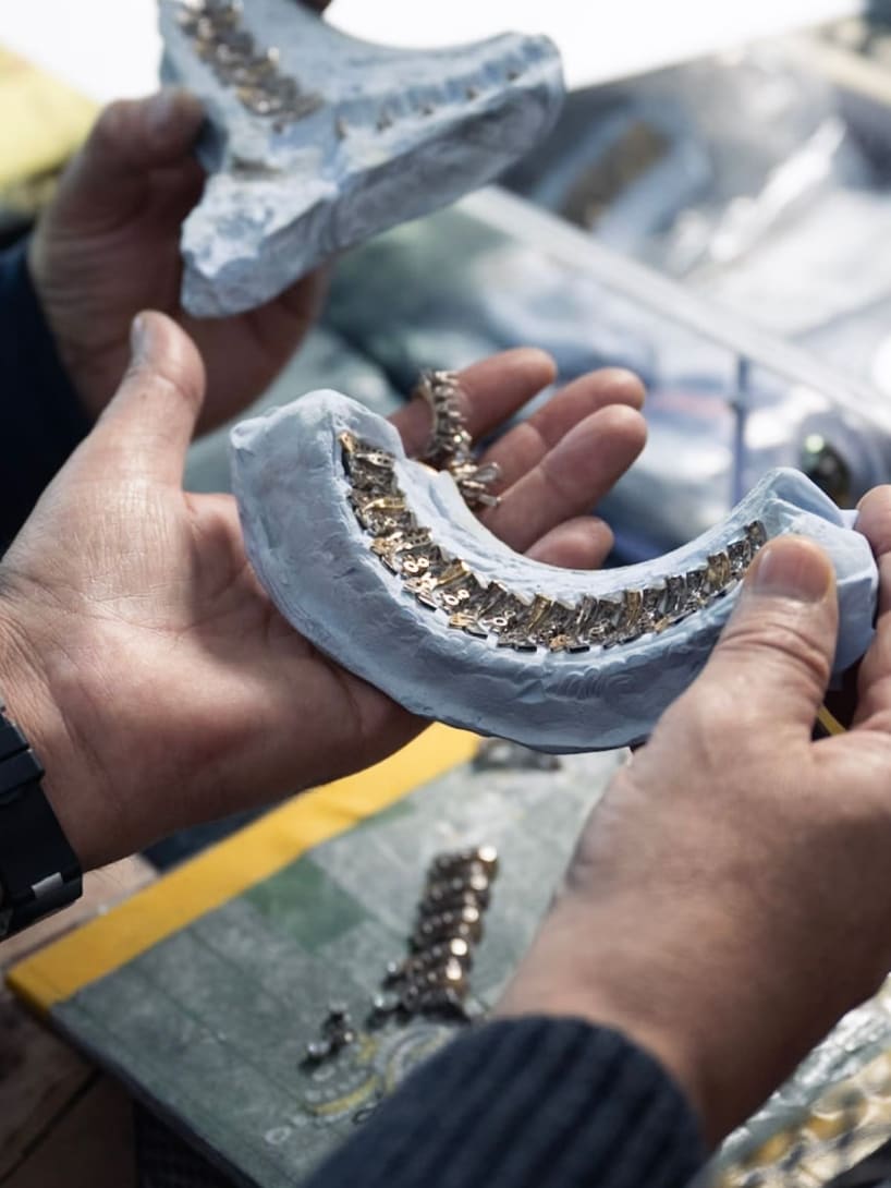 Close up on Massimo's hands, High Jewelry Production Senior Director, handling a jewelry prototype