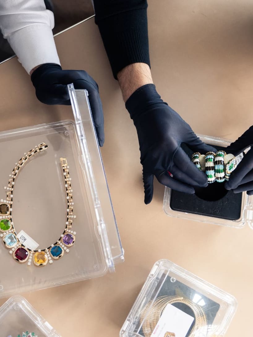 Close up on two Supply Chain employees' hands checking two products 