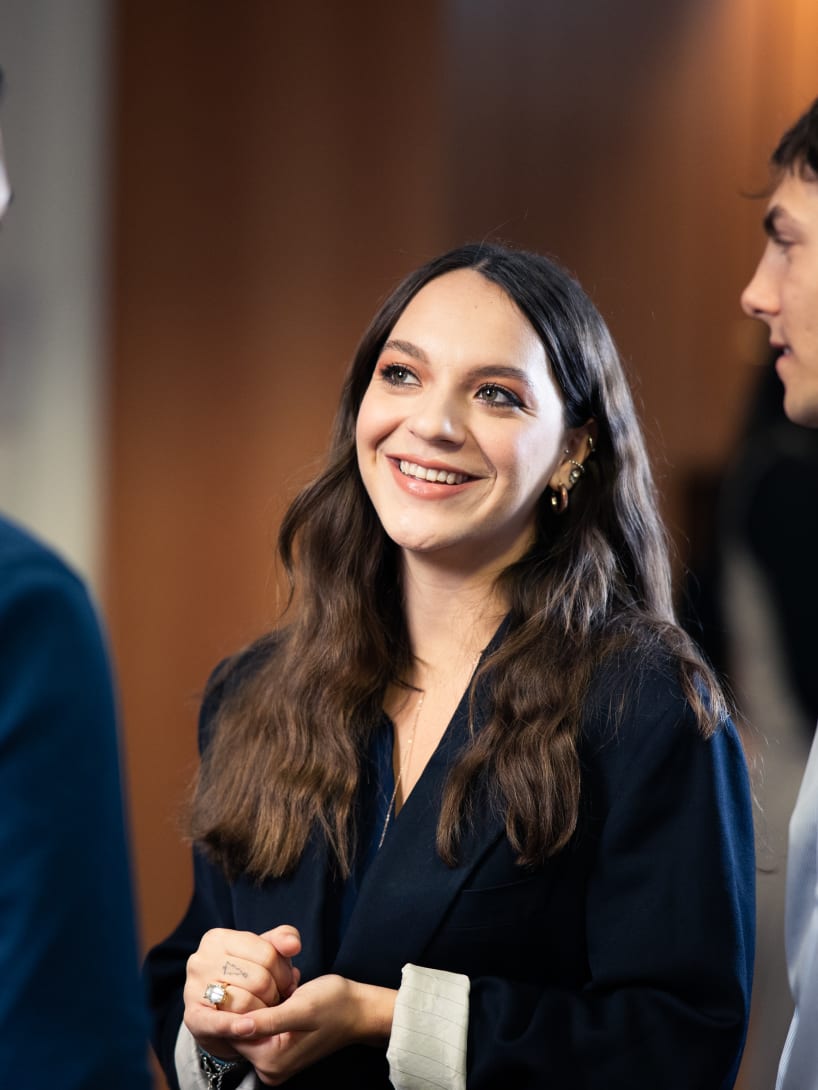 Three smiling young people while conversing