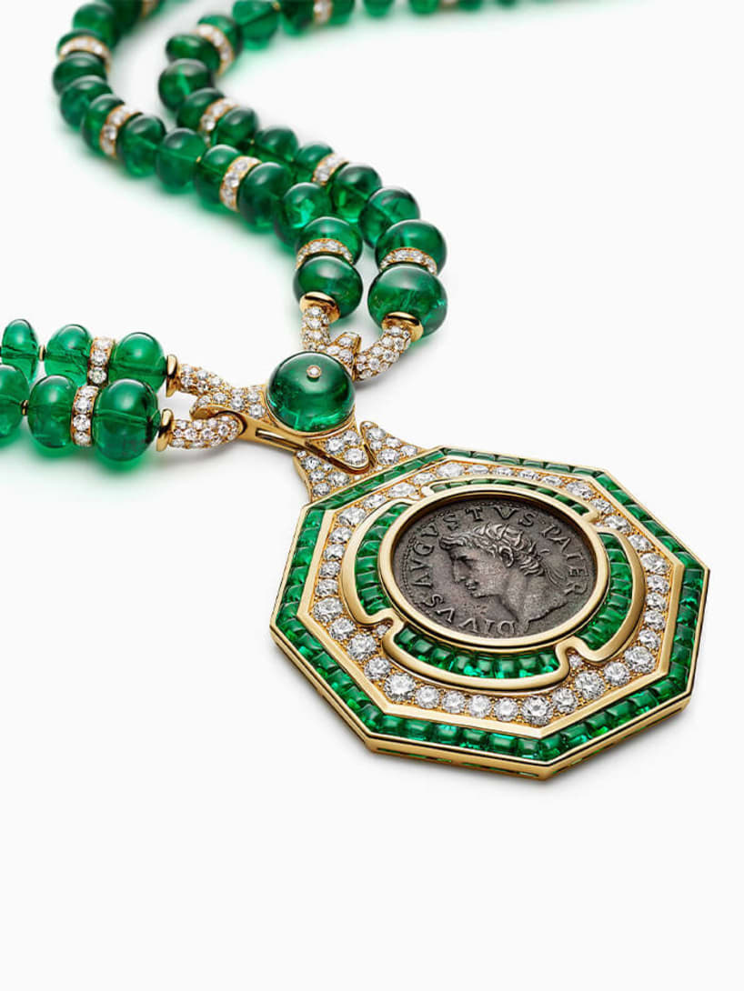 The Augustus Aeternus Emerald Monete High Jewellery sautoir with a rare bronze coin, emeralds and diamonds.