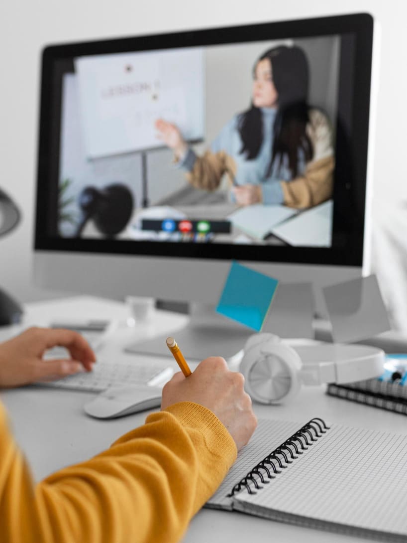 A person in front of a screen while attending a webinar