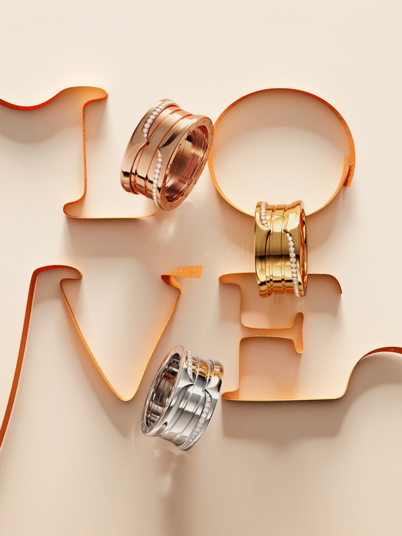 B.zero1 rose, yellow and white gold rings with diamonds on the word LOVE written in orange ribbon.