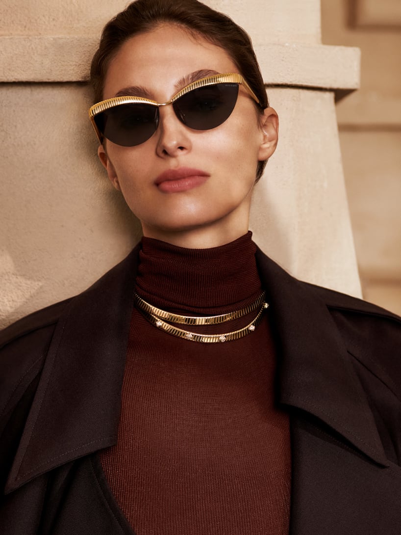 Model wearing Bvlgari Tubogas semi-rimless cat-eye sunglasses and Tubogas necklaces.