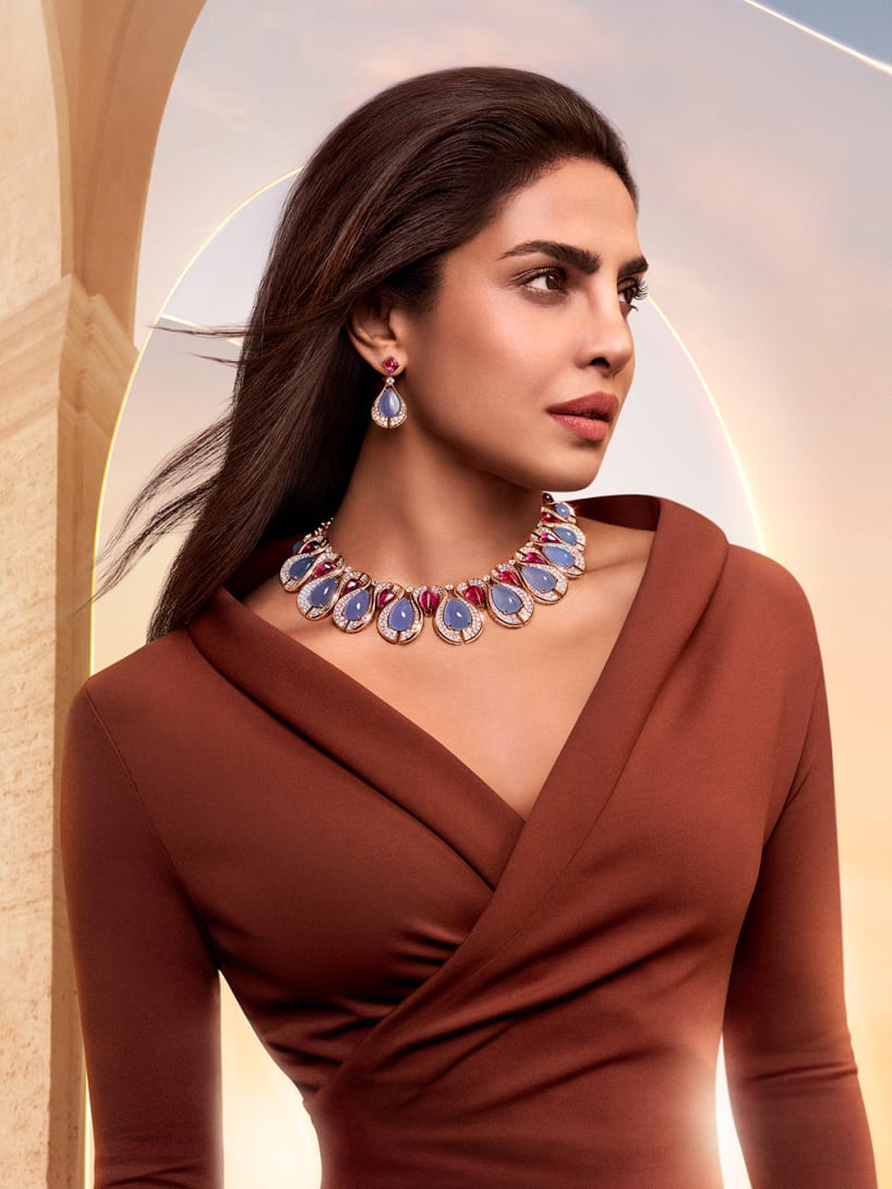 Priyanka Chopra Jonas wearing Bvlgari High Jewellery, dawn sky and Roman architecture in the background.