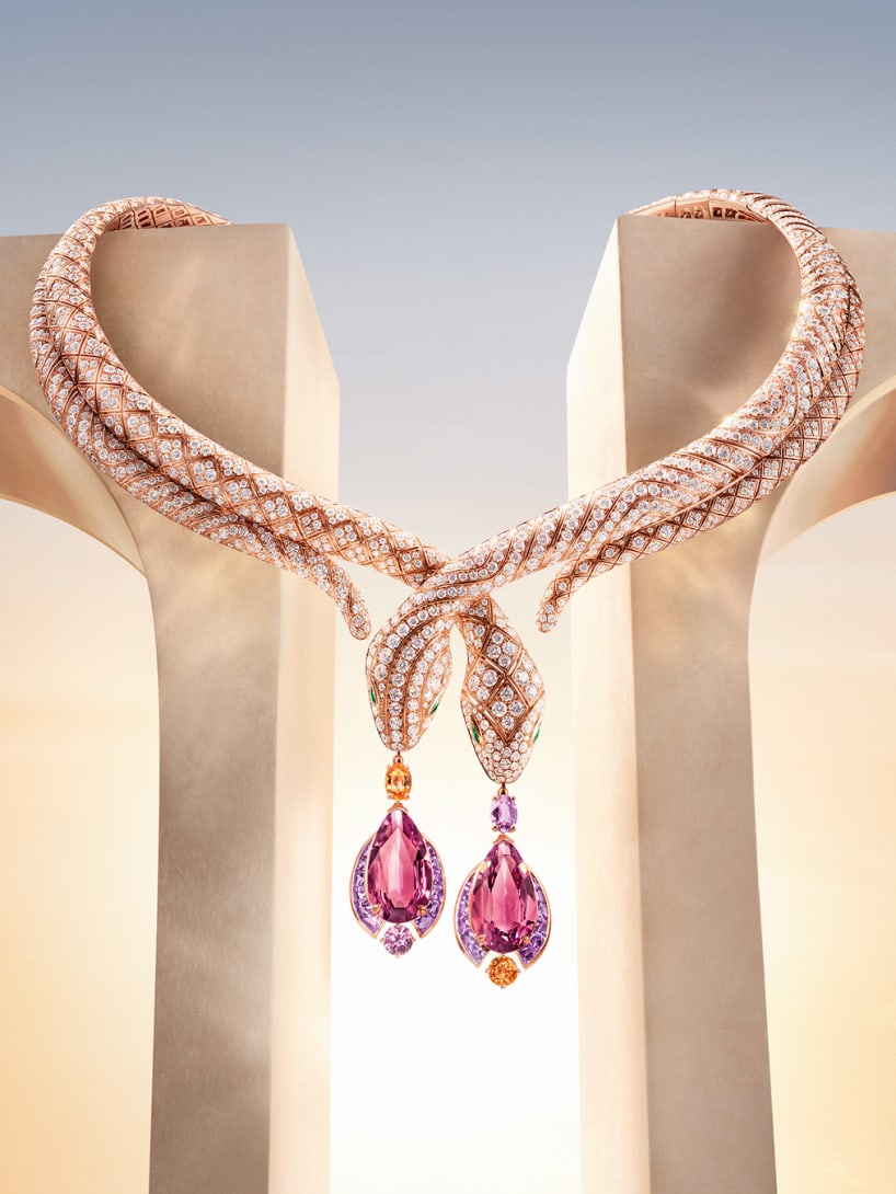 Serpenti High Jewellery necklace set against Roman architectural elements, dawn sky in the background.