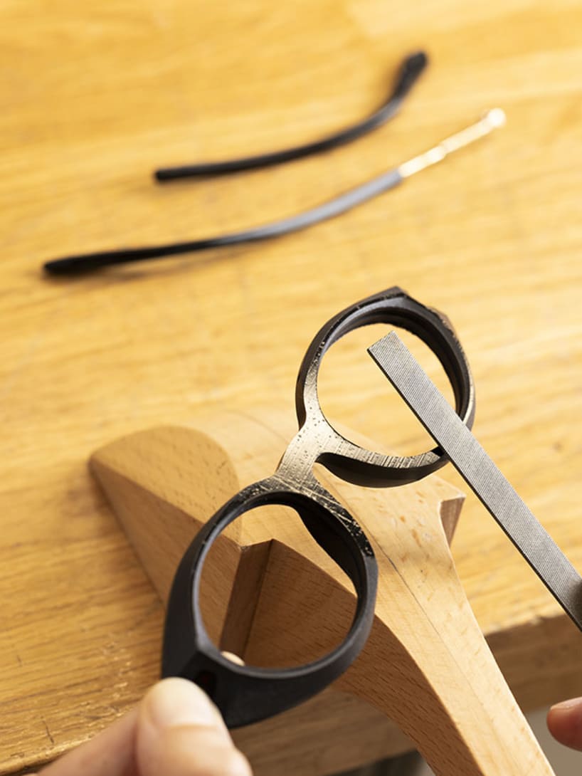 Making of Serpenti Viper glasses, hand-finishing of the acetate frame, close up.