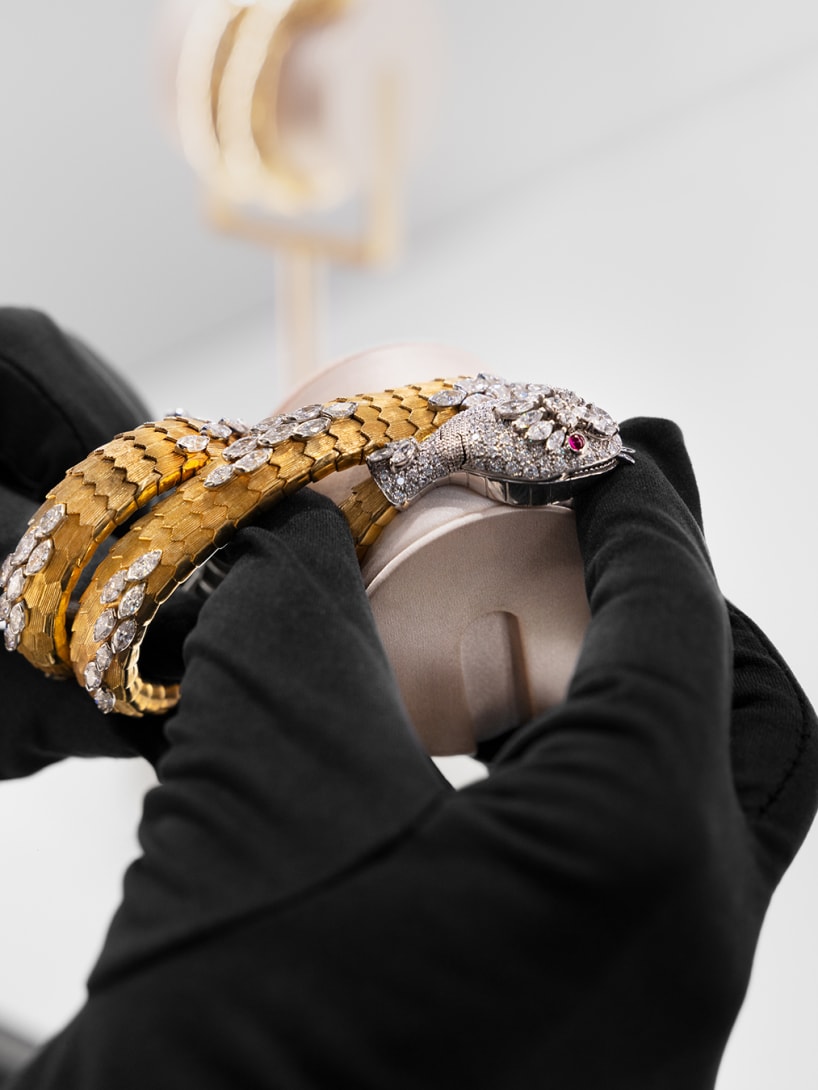 Serpenti High Jewellery yellow and white gold bracelet-watch with diamonds, hands with black gloves.