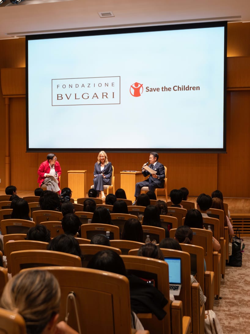 View of the Fondazione Bvlgari & Save the Children masterclass with three speakers and students.