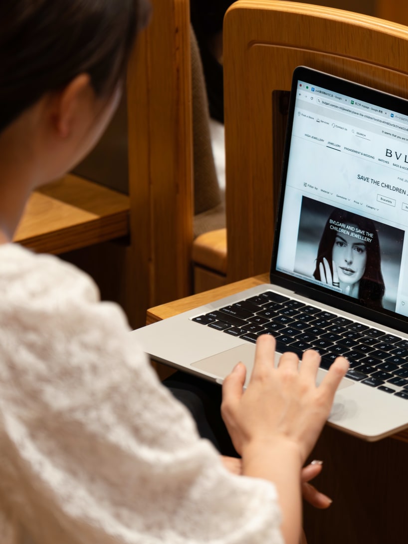 Close-up of a student’s laptop showing the Bvlgari Foundation and Save the Children webpage.
