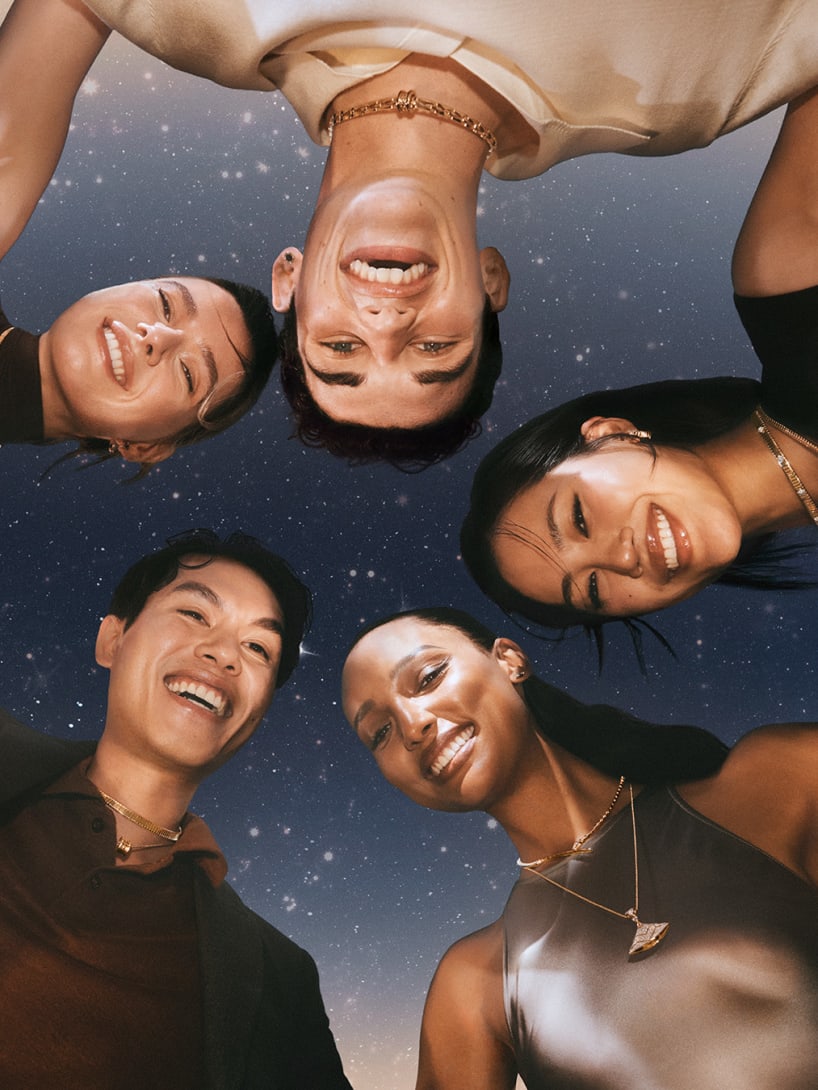 People celebrating the festive season wearing Bvlgari creations in front of a starry night sky.