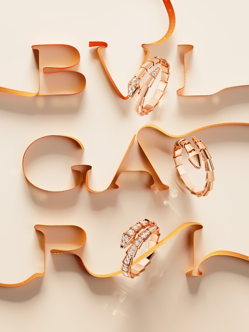 Bvlgari logo made of an orange ribbon, interspersed with Serpenti Viper rose gold and diamond rings.