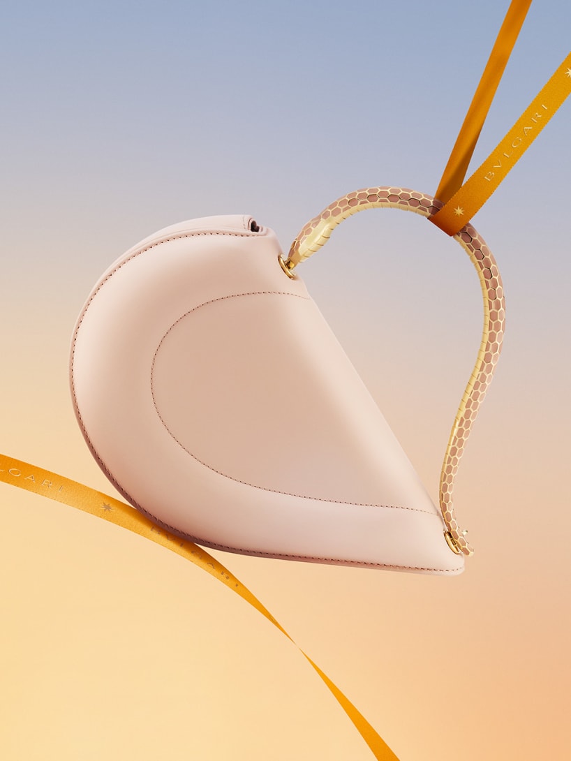 Bvlgari Serpenti Cuore 1968 heart-shaped light pink calf leather top-handle bag with orange ribbon.