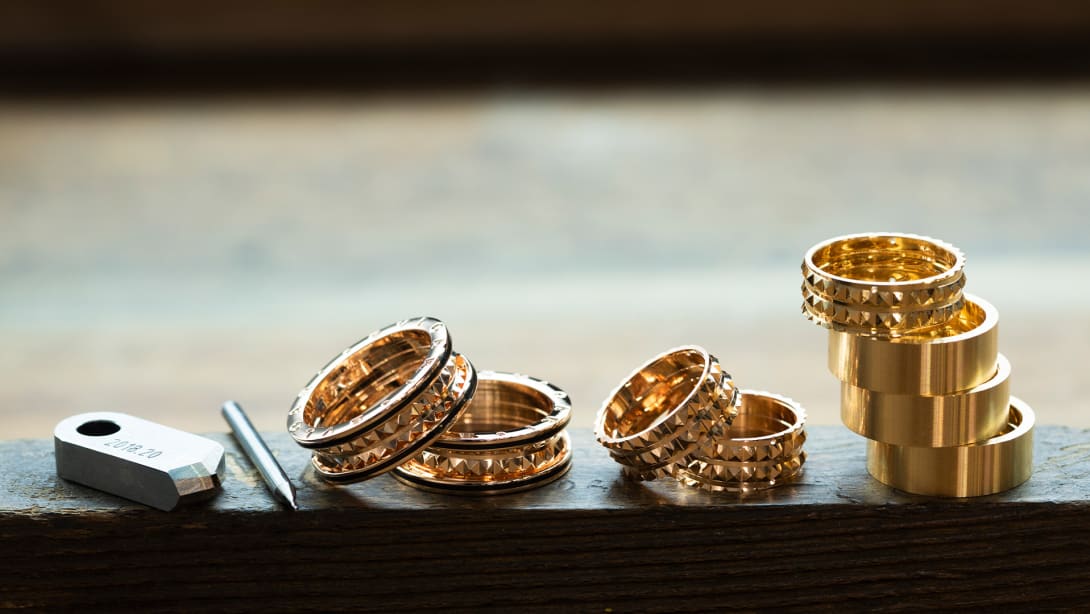 Different stages in the making of B.zero1 Rock yellow gold rings with black ceramic, and goldsmith tools.