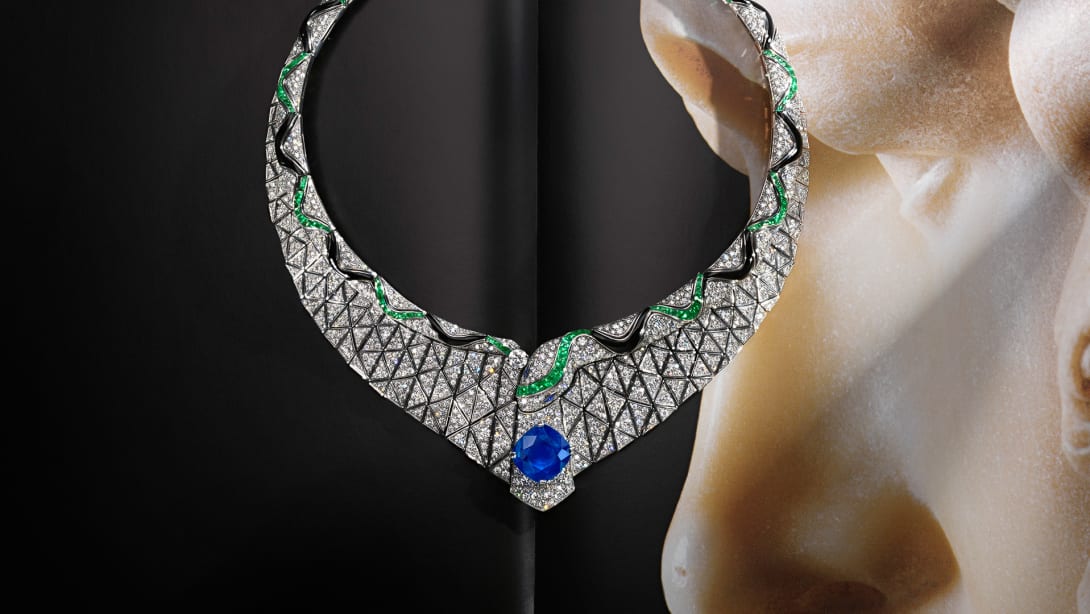 Serpenti Illusio High Jewellery white gold necklace set with a cushion sapphire, diamonds, onyx and emeralds.