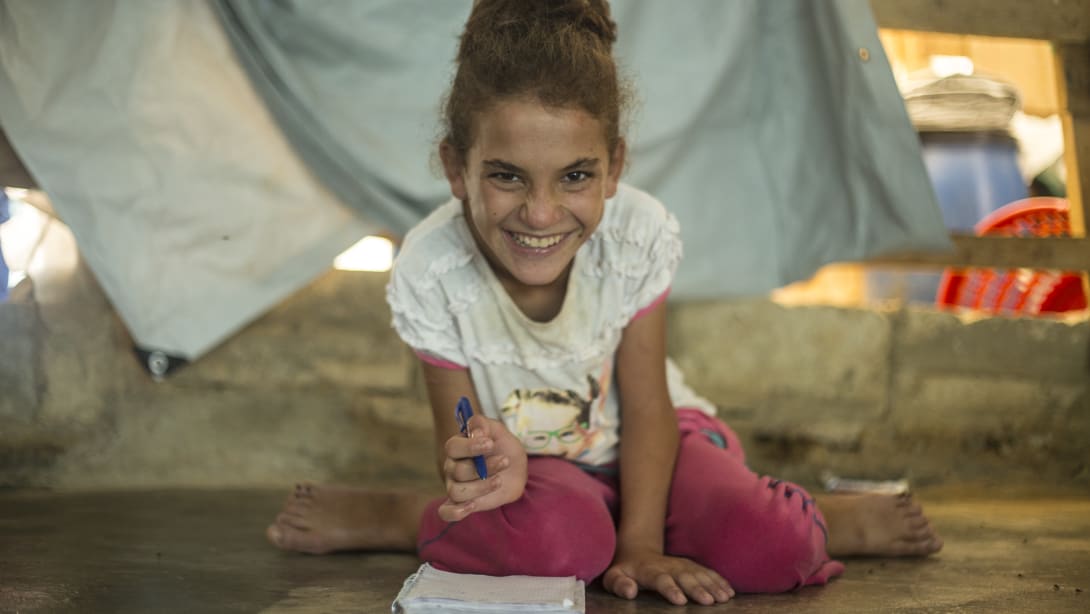 B-for-Beirut and Save the Children. Little girl with a book in her hands.