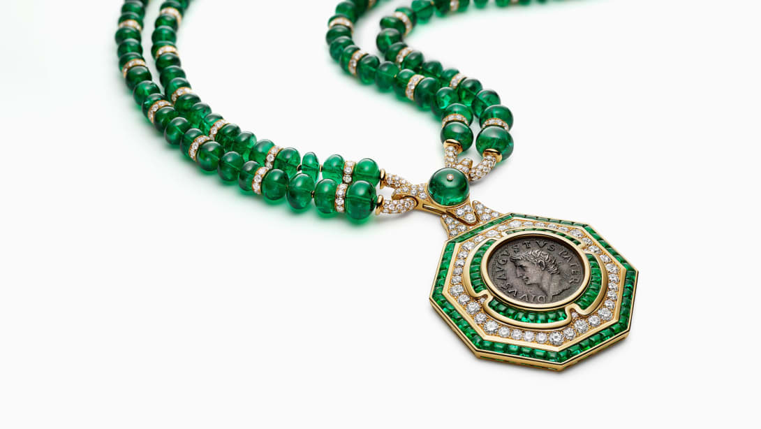 The Augustus Aeternus Emerald Monete High Jewellery sautoir with a rare bronze coin, emeralds and diamonds, full view.